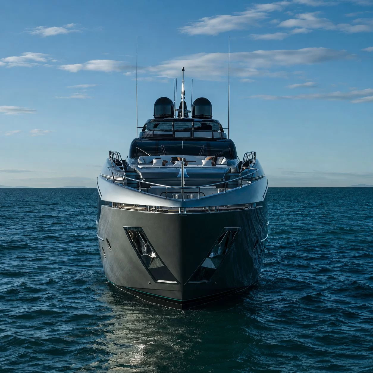 Luxury yacht bow cutting through blue water